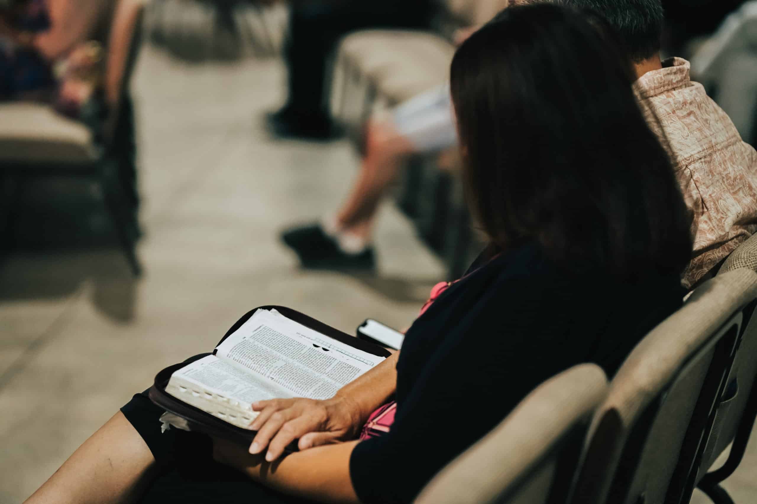 A member reading scripture during worship at Hilltop Wesleyan